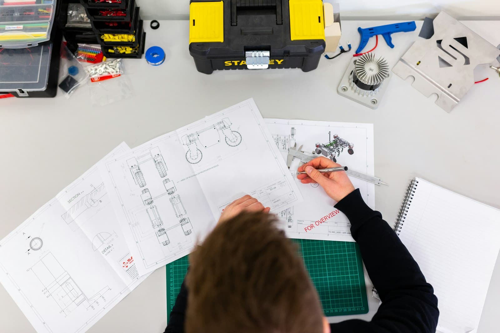A Chebez engineer reviewing technical specifications on the floor
